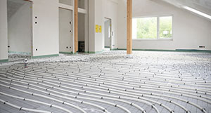 interior room with heating system installation featuring underfloor heating pipes arranged in organized patterns for optimal warmth